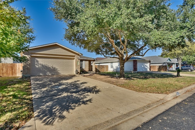 single story home featuring a garage and a front lawn