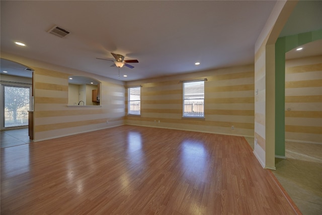 unfurnished living room featuring ceiling fan and wood-type flooring