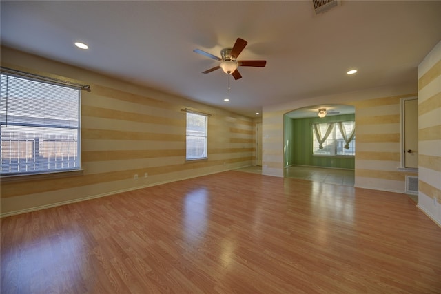 spare room with light hardwood / wood-style flooring and ceiling fan