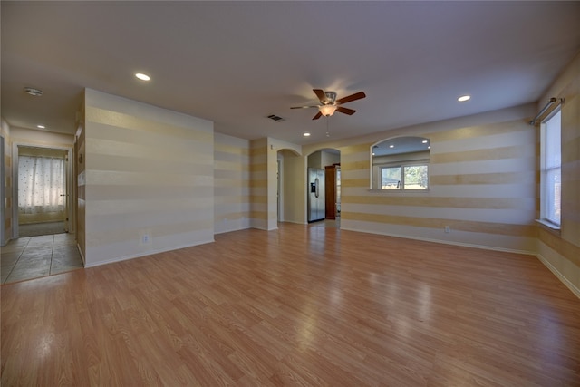 unfurnished living room with ceiling fan and light wood-type flooring