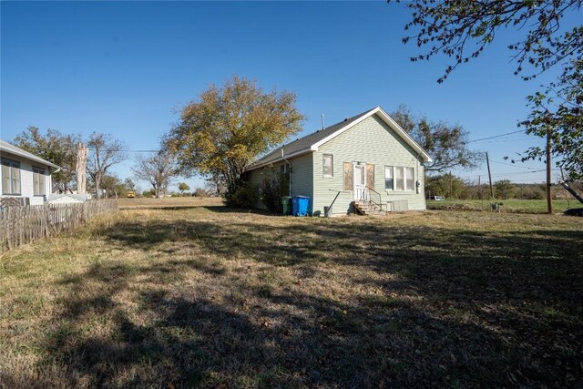 view of side of property with a lawn