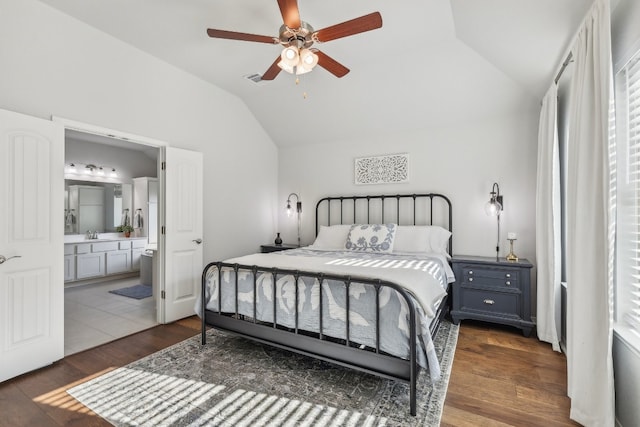 bedroom with dark wood-type flooring, sink, vaulted ceiling, ceiling fan, and connected bathroom