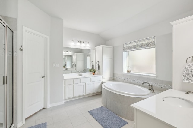 bathroom with tile patterned flooring, vanity, independent shower and bath, and lofted ceiling