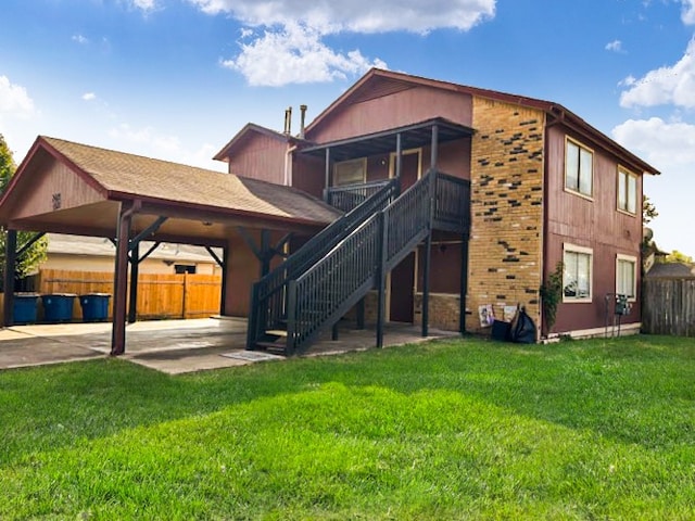 rear view of property with a lawn