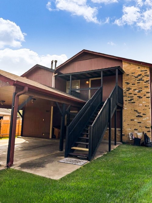 rear view of house featuring a yard