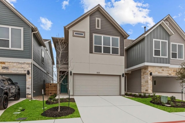 view of front of home with a garage, driveway, stone siding, board and batten siding, and stucco siding