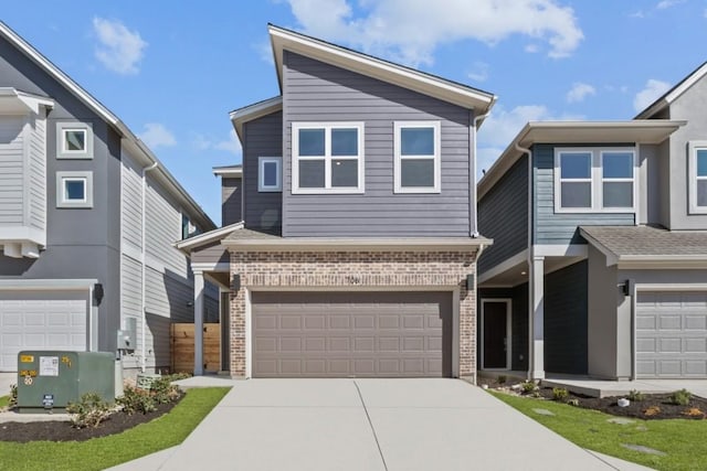 706 Terrier Trl, Austin, TX 78745 - view of front of property with a garage, brick siding, and concrete driveway