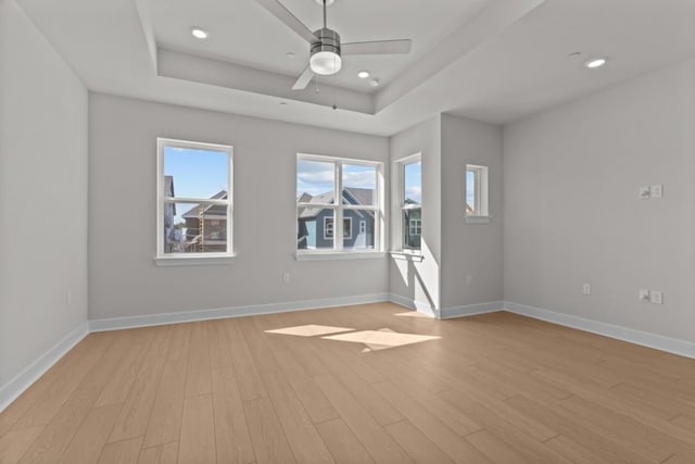 706 Terrier Trl, Austin, TX 78745 - unfurnished room featuring a raised ceiling, light wood-style flooring, a ceiling fan, and recessed lighting