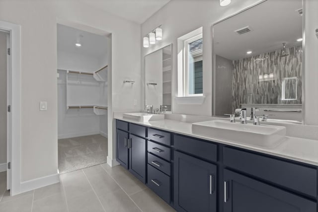 706 Terrier Trl, Austin, TX 78745 - full bathroom with double vanity, a walk in closet, a walk in shower, and tile patterned flooring