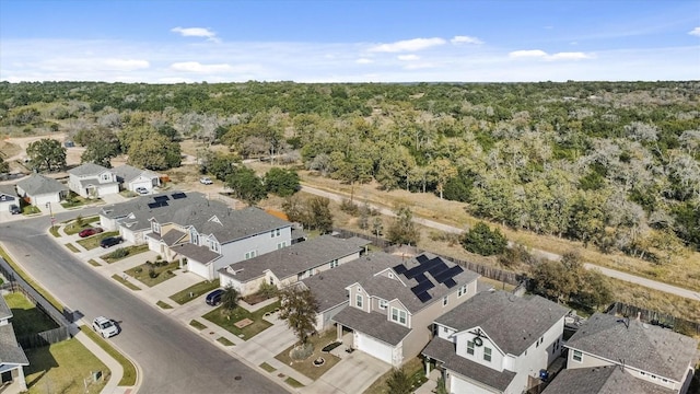 drone / aerial view with a forest view and a residential view