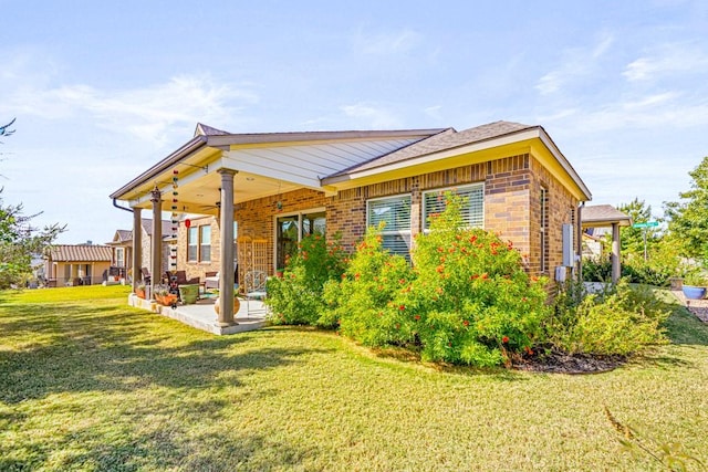 back of property with a patio and a lawn