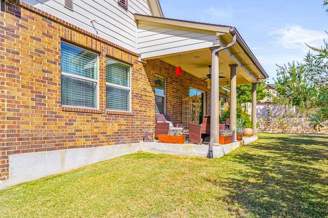 property entrance featuring a yard, a patio area, and ceiling fan