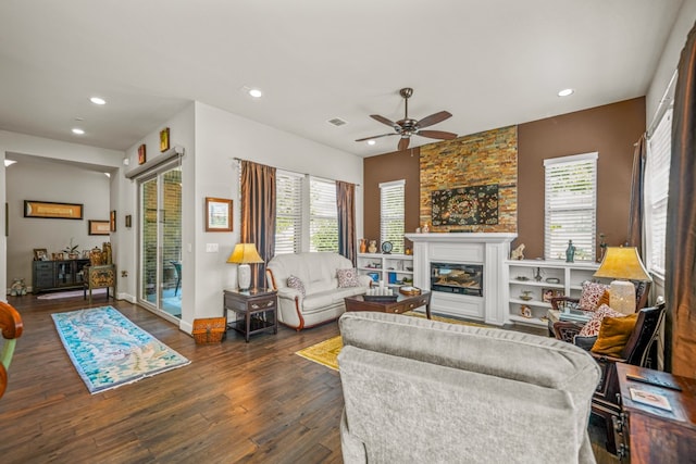 living room with ceiling fan and dark hardwood / wood-style flooring