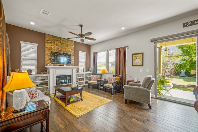 living room featuring ceiling fan and dark hardwood / wood-style flooring