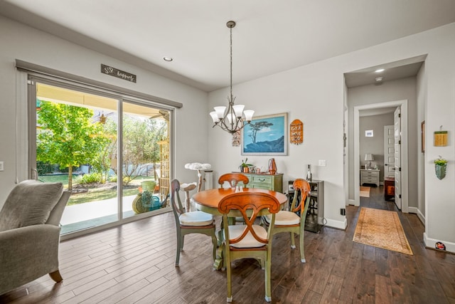 dining area featuring dark hardwood / wood-style flooring and a chandelier