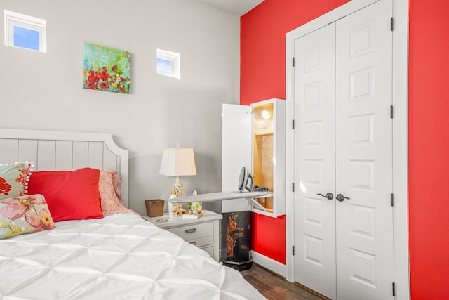 bedroom featuring dark hardwood / wood-style floors and a closet