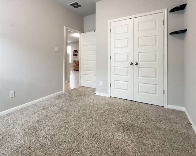 unfurnished bedroom with carpet and a closet