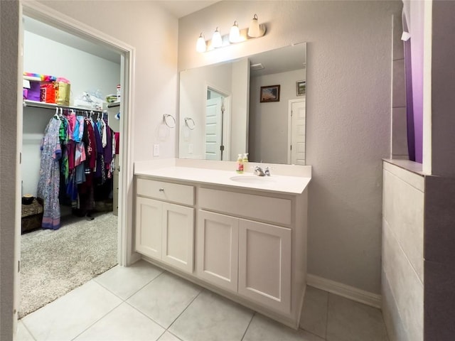 249 El Dorado Rd, Jarrell, TX 76537 - bathroom featuring tile patterned flooring, vanity, and a spacious closet