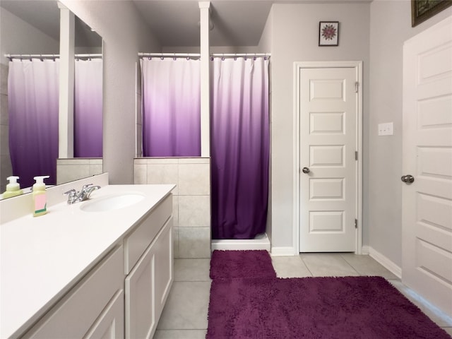 bathroom with curtained shower, tile patterned flooring, and vanity