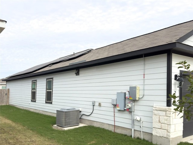 249 El Dorado Rd, Jarrell, TX 76537 - view of home's exterior featuring roof mounted solar panels, a yard, and roof with shingles