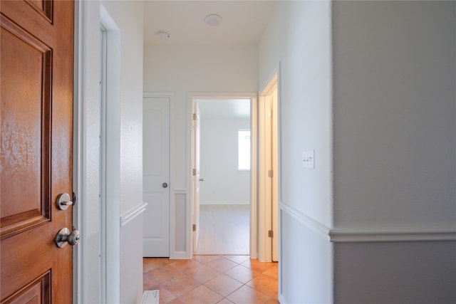 hall featuring light tile patterned flooring