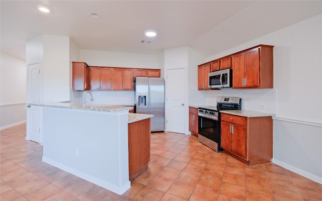 kitchen featuring light stone counters, light tile patterned floors, sink, and appliances with stainless steel finishes