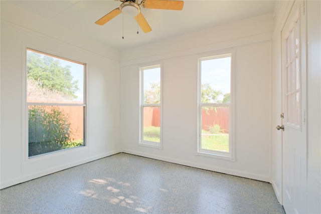 spare room featuring a wealth of natural light and ceiling fan