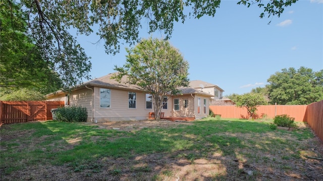 rear view of house featuring a yard