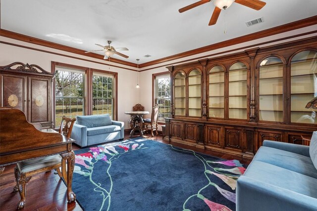 living area featuring dark hardwood / wood-style flooring and ornamental molding