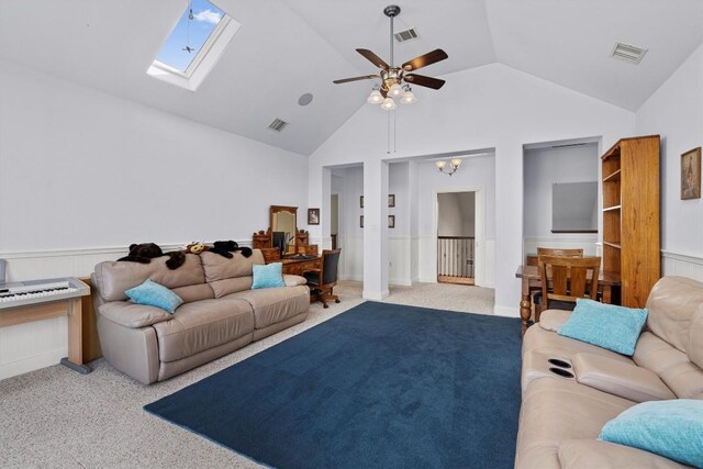 carpeted living room featuring a skylight, high vaulted ceiling, and ceiling fan