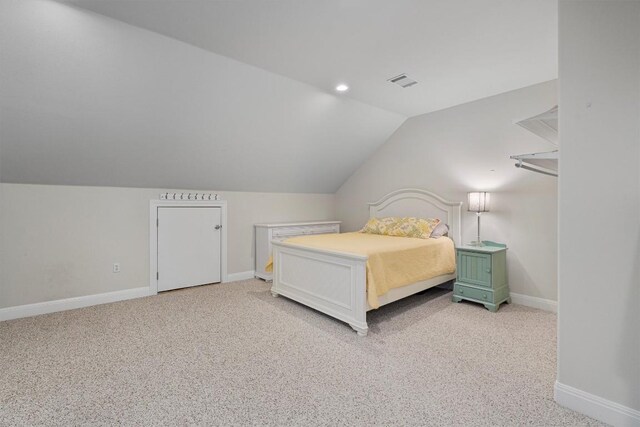 carpeted bedroom featuring lofted ceiling