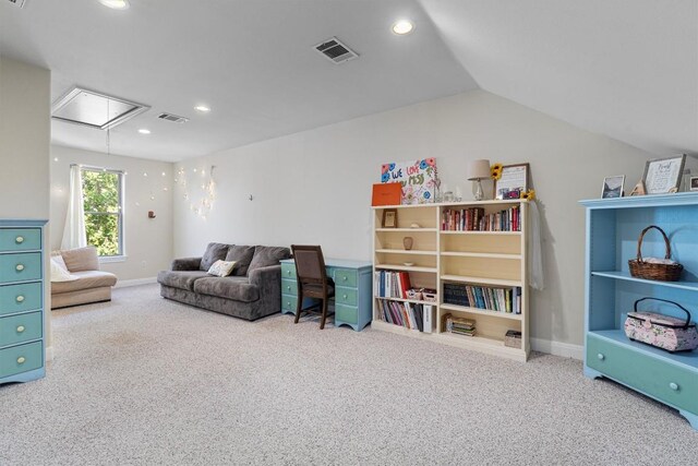 carpeted living room with lofted ceiling