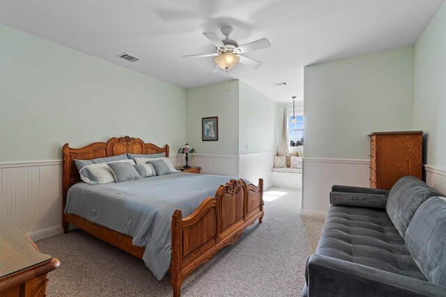 bedroom featuring light colored carpet and ceiling fan