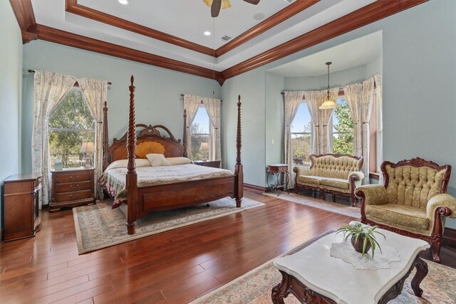 bedroom featuring multiple windows, ceiling fan, dark hardwood / wood-style flooring, and crown molding