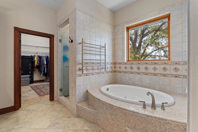 bathroom with tile patterned flooring and shower with separate bathtub