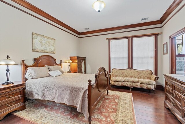 bedroom with crown molding and dark hardwood / wood-style flooring