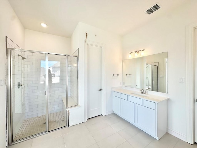 bathroom with tile patterned floors, vanity, and an enclosed shower