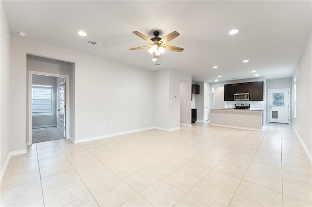 unfurnished living room featuring ceiling fan and light tile patterned flooring