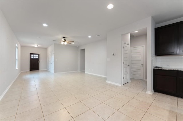 unfurnished living room with ceiling fan and light tile patterned flooring