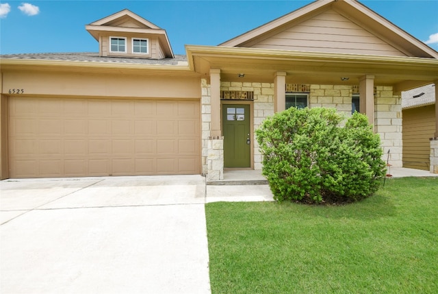 view of front of house with a porch, a front yard, and a garage