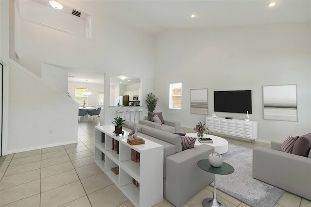 tiled living room with a chandelier and high vaulted ceiling