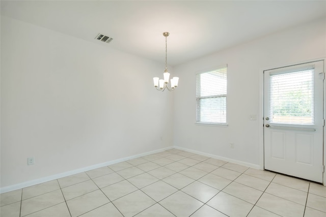 interior space with a wealth of natural light, light tile patterned floors, and a chandelier