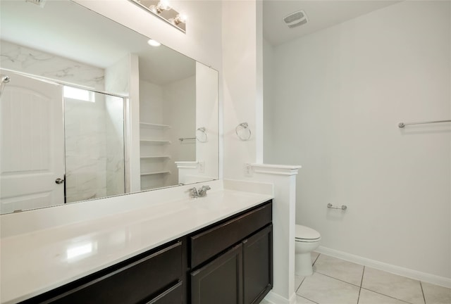 bathroom with tile patterned flooring, vanity, toilet, and a shower with door