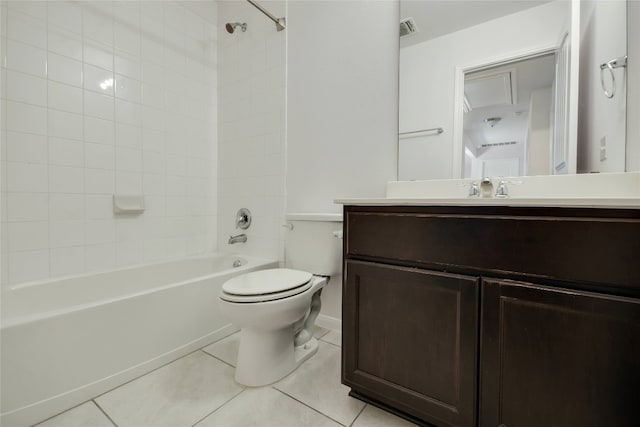 full bathroom with tile patterned flooring, vanity, tiled shower / bath combo, and toilet