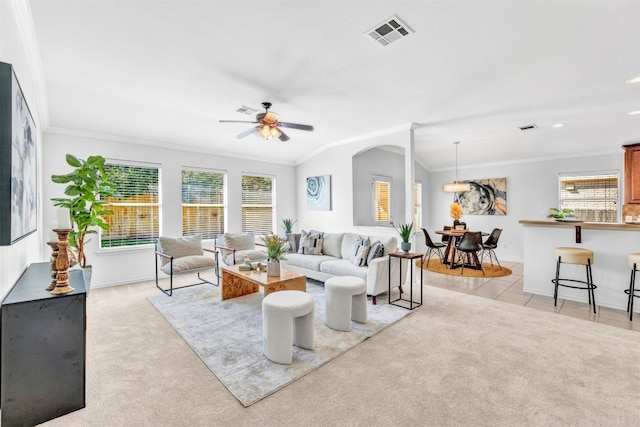 living room featuring ceiling fan, light colored carpet, lofted ceiling, and crown molding