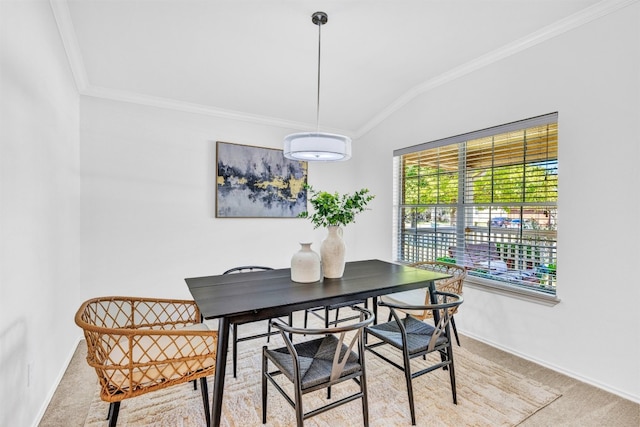 carpeted dining room featuring vaulted ceiling and crown molding