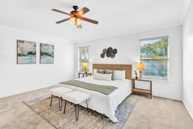 carpeted bedroom with ceiling fan and ornamental molding