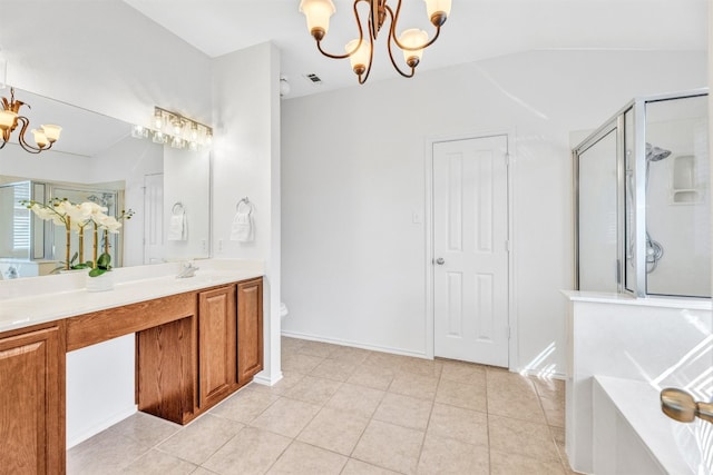 bathroom with tile patterned flooring, vanity, a shower with door, and a notable chandelier