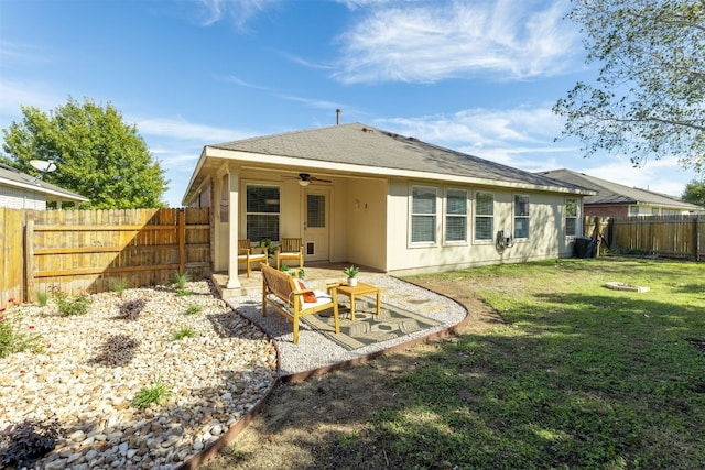 back of property featuring a yard, outdoor lounge area, ceiling fan, and a patio area