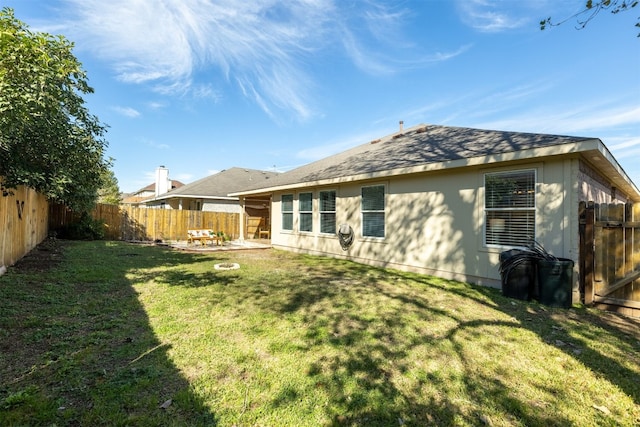 back of house featuring a patio area and a yard